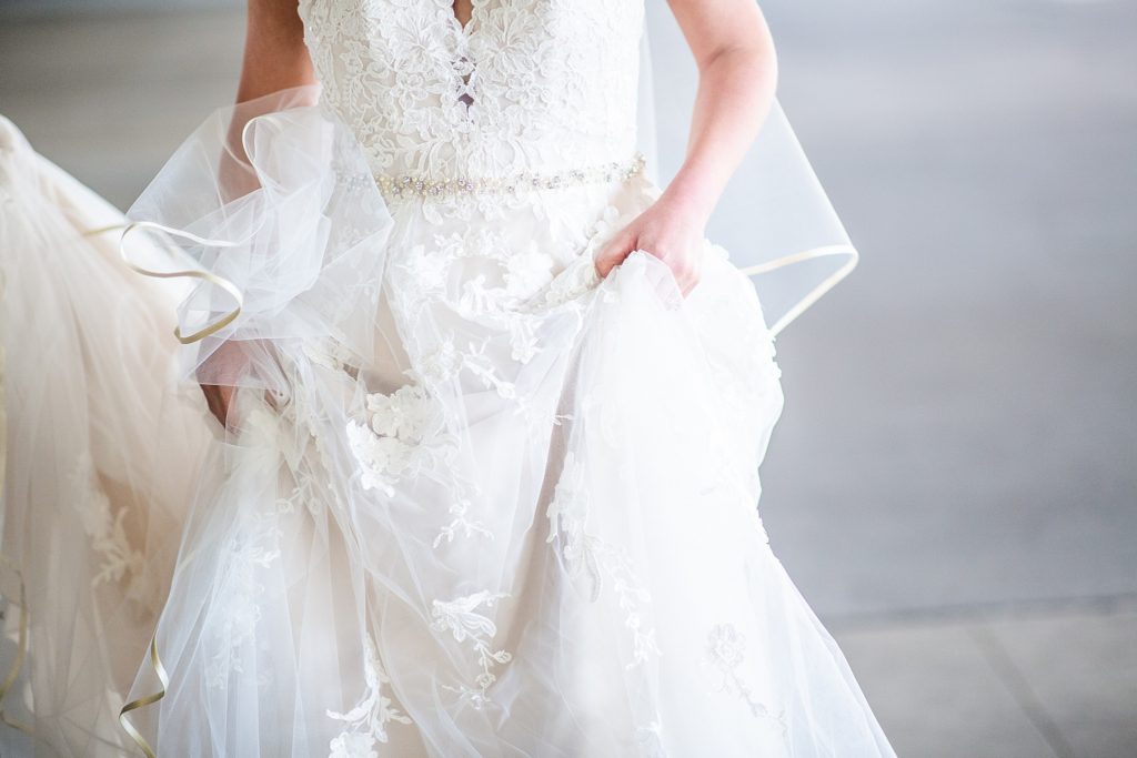 Bride holding dress up