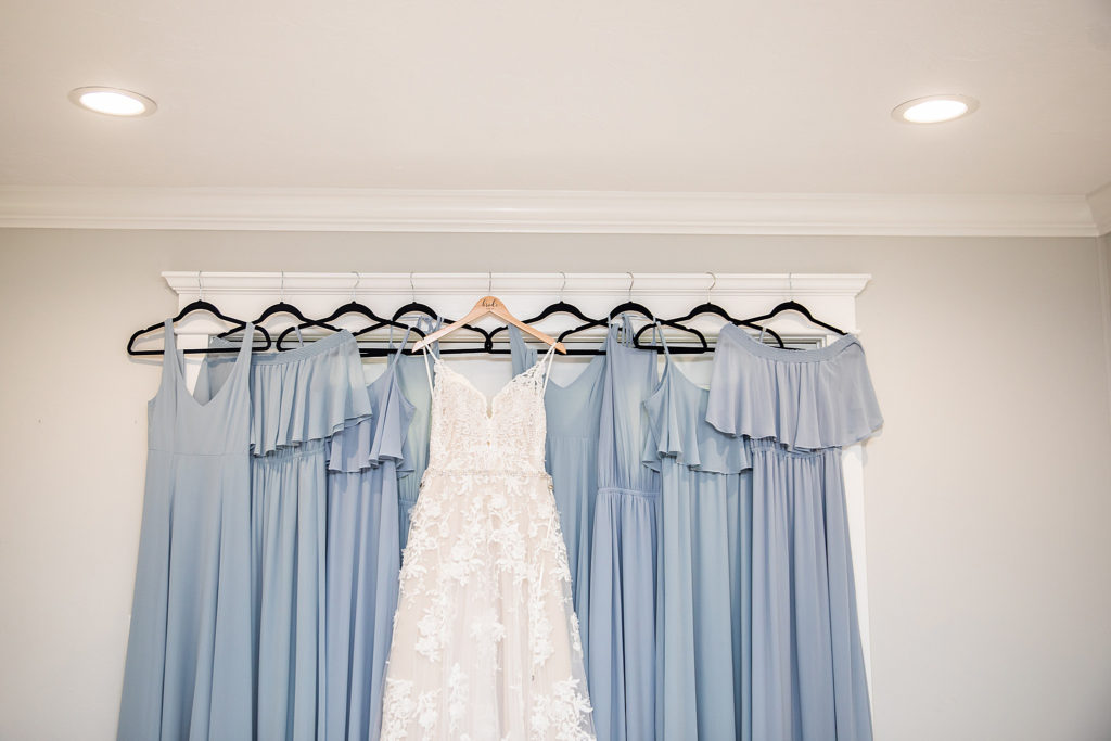 power blue dresses hanging with wedding dress